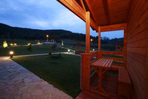 a porch of a cabin with a bench at night at La Cabaña Rural in Paúl