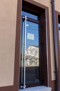 a glass door of a building with a sign in it at Express Residence in Brăila