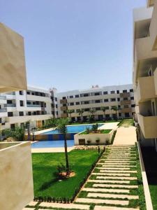 a view of a courtyard of a building with a tree at Paradise beach in Mohammedia