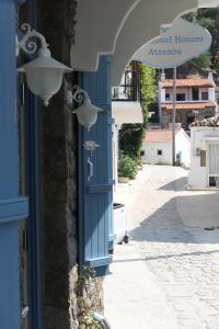 a blue door on a building with a street at Traditional Houses Atzanou in Samothráki