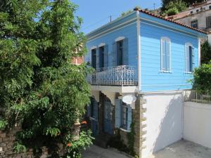 a blue and white house with a balcony at Traditional Houses Atzanou in Samothráki
