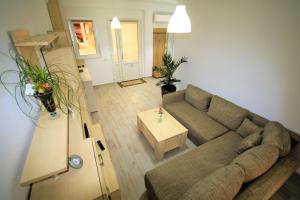 a living room with a couch and a table at Aby sunrise in Orşova