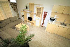 a large living room with a couch and a kitchen at Aby sunrise in Orşova