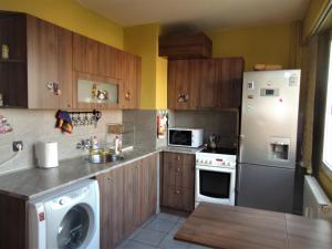 a kitchen with a white refrigerator and a sink at Business Park Apartment in Sofia
