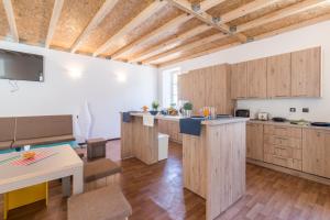 a kitchen with wooden cabinets and a counter top at Hostel Antique in Pula
