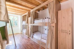 a room with bunk beds in a tiny house at Hostel Antique in Pula