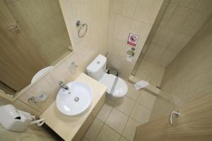 a bathroom with a sink and a toilet and a mirror at Aby sunrise in Orşova +173 photos