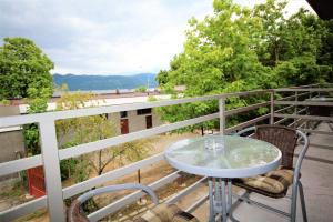a table and chairs on a balcony with a view at Aby sunrise in Orşova