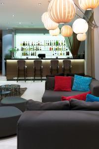 a living room with a couch and a bar at Home Hotel Aurora in Tromsø