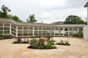 a glass greenhouse with plants in a garden at The Regency Hotel in Solihull