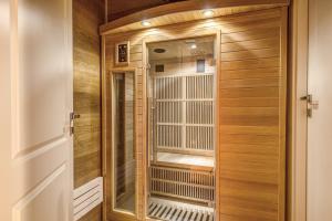 a walk in shower in a room with wood at Charme Spagna Boutique Hotel in Rome