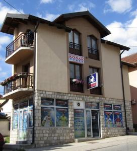 a building with posters on the side of it at Apartment and rooms Konak in Višegrad