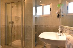 a bathroom with a sink and a shower at Pension Asun Sanxenxo in Sanxenxo