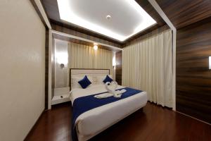 a bedroom with a bed with a flower on it at Hotel Silver Heights in Ahmedabad