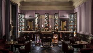 a bar in a room with chairs and tables at The Gleneagles Hotel in Auchterarder