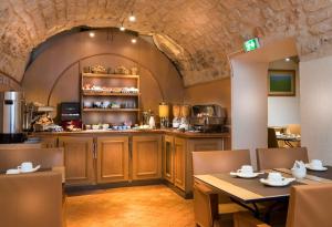 a kitchen with a table and chairs and a counter at Lautrec Opera in Paris