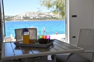 a table with a tray of food and a bottle of beer at Beachfront Apartments - Villa Vita in Stara Novalja