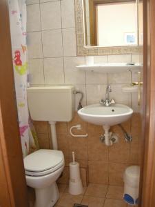 a small bathroom with a toilet and a sink at Muses in Neos Marmaras