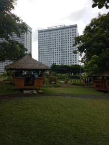 a park with a gazebo and a tall building at Wind Residences Apt. 1506 Tagaytay in Tagaytay
