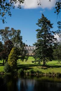 an image of a house with a tree and a lake at The Gleneagles Hotel in Auchterarder