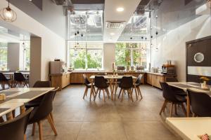 a restaurant with tables and chairs and a counter at Old Town Trio in Vilnius