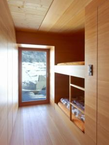 a room with a window and a wooden wall at Chalet Le Biolley in Orsières