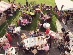 an overhead view of a crowd of people sitting at tables at Luscher & Matiesen Muhu Winehouse in Liiva