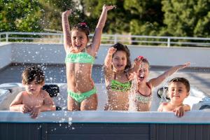 a group of children playing in a hot tub at La Terrazza di Harmakhis in Partanna