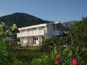 a large white house with mountains in the background at Anika apart in Bar