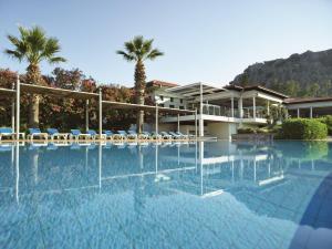 a swimming pool in front of a resort at TUI BLUE Sarigerme Park in Dalaman