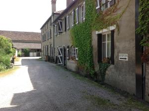 een lege straat naast een gebouw met klimop bij Hostellerie du Vieux Moulin in Autun