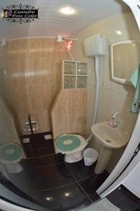 a small bathroom with a toilet and a sink at Hospedaria Gaúcha in Penha +44 photos