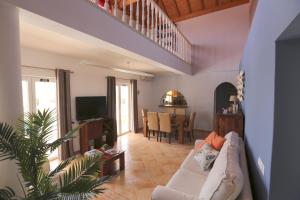 a living room with a couch and a table at Quinta do Pinheiro Manso - Holidays Villa - Marinha Beach in Carvoeiro