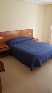 Кровать или кровати в номере Hostal Orly