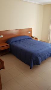 A bed or beds in a room at Hostal Orly