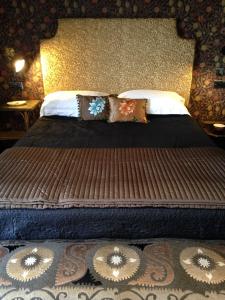 a large bed with pillows on it in a bedroom at Gower View Luxury Bed & Breakfast in Tenby