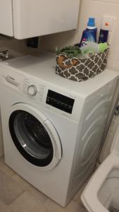 a white washing machine with a basket on top of it at Sophienstrasse Appartement in Baden-Baden