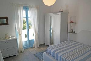 a bedroom with a bed and a dresser and a window at Home Sweet Home in Plaka