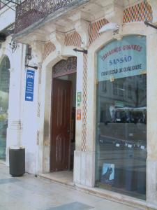 a store front of a building with a window at Pensão Santa Cruz in Coimbra