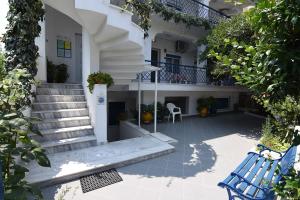a blue bench sitting in front of a building at Villa Stegiovana in Stavros