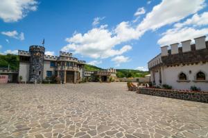 an empty courtyard of a castle with a blue sky at LaCetate Boutique Hotel in Piteşti