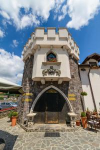 a building with a tower with a window at Hotel LaCetate in Piteşti