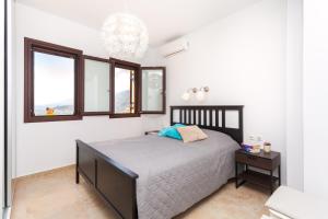 A bed or beds in a room at Wormwood - Morfi Village