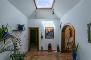 a hallway with white walls and a skylight at Villa El Jable Lanzarote in Teguise