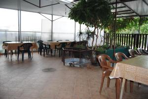 a dining room with tables and chairs and windows at Joleski Accommodation in Ohrid