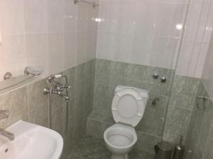 a bathroom with a toilet and a sink at Къща за гости Кадиеви in Primorsko