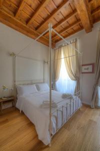 a bedroom with a canopy bed with a window at Assaporarte in Florence