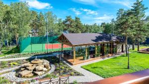 a pavilion with a tennis court in a park at Rufus Lodge in Kotarkol