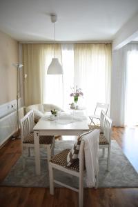 a living room with a white table and chairs at Apartment Sneshka in Ohrid