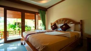 a bedroom with a large bed and a large window at Starlight Resort Koh Phangan in Thong Nai Pan Yai